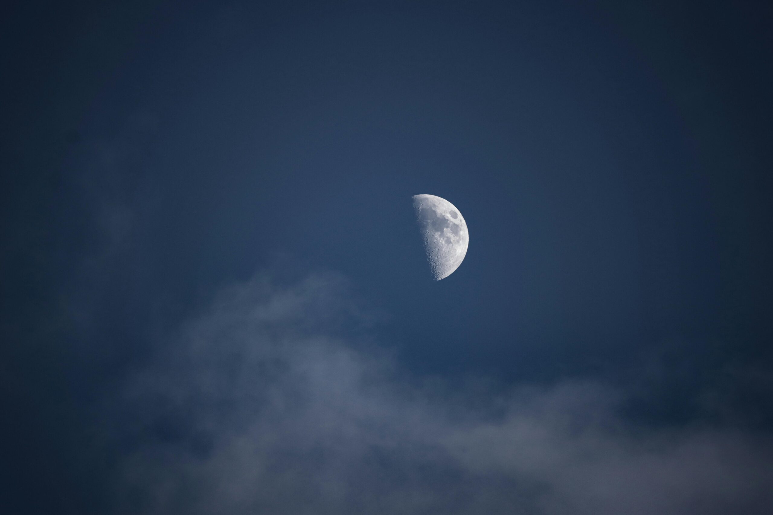 Captivating half moon in a serene night sky over Jönköping, Sweden.